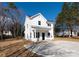 Charming two-story home with white siding, black door and windows, and a covered front porch at 8705 Moody Rd, Charlotte, NC 28215