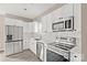 Eat-in kitchen features new stainless steel appliances, white cabinetry, and bright natural light at 8705 Moody Rd, Charlotte, NC 28215
