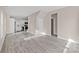 Open concept living area with gray floors, white trim, and a view of the kitchen with stainless appliances at 8705 Moody Rd, Charlotte, NC 28215