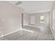 Bright living room with neutral paint, lovely gray floors, and a large window to let the sunshine in at 8705 Moody Rd, Charlotte, NC 28215