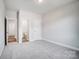 Carpeted bedroom with multiple doorways and neutral color scheme at 8720 Acadia Pkwy # 597, Sherrills Ford, NC 28673