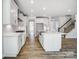 Open kitchen with a large island, stainless steel appliances, and views of the staircase at 8720 Acadia Pkwy # 597, Sherrills Ford, NC 28673