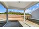 A covered patio overlooks a grass and mulch backyard with views of mature trees at 8720 Acadia Pkwy # 597, Sherrills Ford, NC 28673