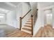 Staircase with wood railing and trim contrasted by white walls and black iron at 8720 Acadia Pkwy # 597, Sherrills Ford, NC 28673