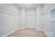 Spacious walk-in closet featuring ample shelving and carpeted floor at 8720 Acadia Pkwy # 597, Sherrills Ford, NC 28673