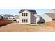 Two-story home with a solar panel roof and a small backyard patio at 9022 Colwick Hill Ln, Charlotte, NC 28215