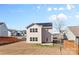 Two-story home with a solar panel roof and a small backyard patio at 9022 Colwick Hill Ln, Charlotte, NC 28215