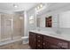 Bright bathroom features a glass shower, double sink vanity, and large mirror at 9022 Colwick Hill Ln, Charlotte, NC 28215