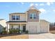 Two-story home featuring a two-car garage and a welcoming front porch at 9022 Colwick Hill Ln, Charlotte, NC 28215