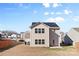 Two-story home with a solar panel roof and a small backyard patio at 9022 Colwick Hill Ln, Charlotte, NC 28215