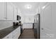 Modern kitchen with white cabinets, stainless steel appliances, and granite countertops at 9022 Colwick Hill Ln, Charlotte, NC 28215