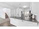 Bright kitchen featuring granite countertops, white cabinets, stainless steel appliances, and hardwood floors at 9022 Colwick Hill Ln, Charlotte, NC 28215