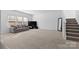 Spacious living room featuring a large picture window, modern decor, and plush carpeting at 9022 Colwick Hill Ln, Charlotte, NC 28215