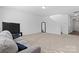 Spacious living room featuring a large picture window, modern decor, and plush carpeting at 9022 Colwick Hill Ln, Charlotte, NC 28215