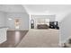 Spacious living room featuring a large picture window, modern decor, and plush carpeting at 9022 Colwick Hill Ln, Charlotte, NC 28215