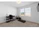 Home office with a treadmill, natural light, and neutral paint at 9022 Colwick Hill Ln, Charlotte, NC 28215