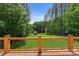 Backyard view of lush lawn, mature trees, and private dock on lake at 9181 Fair Oak Dr, Sherrills Ford, NC 28673