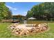 Private beach with a beach umbrella and chairs with lake and boat dock at 9181 Fair Oak Dr, Sherrills Ford, NC 28673