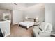 Spacious bedroom featuring neutral tones, plush carpeting, and a comfortable seating area at 946 E 8Th St, Charlotte, NC 28204