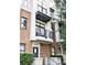 Brick townhouse exterior highlighting a private balcony, modern design, and well-maintained landscaping at 946 E 8Th St, Charlotte, NC 28204