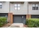 Attached garage with gray door, complemented by brick accents and manicured landscaping at 946 E 8Th St, Charlotte, NC 28204