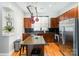 Well-equipped kitchen features a granite island, wood cabinets, and stainless steel appliances at 946 E 8Th St, Charlotte, NC 28204