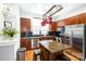 Kitchen featuring wood cabinets, stainless steel appliances and a breakfast bar with granite countertop at 946 E 8Th St, Charlotte, NC 28204