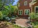 Spacious brick backyard patio with multiple chairs and tables, surrounded by lush trees at 9743 Aegean Ct, Huntersville, NC 28078