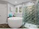 Updated bathroom boasts a large soaking tub and glass shower with tiled accents at 9743 Aegean Ct, Huntersville, NC 28078