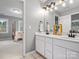 Bright bathroom features a double sink vanity and a view into the bedroom through a doorway at 9743 Aegean Ct, Huntersville, NC 28078