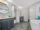 Beautiful bathroom featuring double vanities, marble counters, and a soaking tub at 9743 Aegean Ct, Huntersville, NC 28078