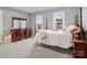 Cozy bedroom features two windows and a four-poster bed with grey walls and carpet at 9743 Aegean Ct, Huntersville, NC 28078