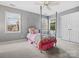Bedroom features a metal four-poster bed, a ceiling fan, and natural light from two windows at 9743 Aegean Ct, Huntersville, NC 28078