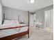 Bright bedroom features a four-poster bed, a vanity with a stool, and grey walls with carpet at 9743 Aegean Ct, Huntersville, NC 28078