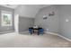 Attic bedroom with dark table, blue chairs, carpet and light grey walls at 9743 Aegean Ct, Huntersville, NC 28078