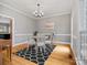 Cozy dining area with modern lighting and decor, set on beautiful hardwood floors at 9743 Aegean Ct, Huntersville, NC 28078
