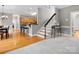 Stylish entryway with hardwood floors, modern staircase, and open access to the kitchen at 9743 Aegean Ct, Huntersville, NC 28078