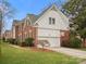 Beautiful two-story brick and siding home with attached garage, and well-manicured lawn at 9743 Aegean Ct, Huntersville, NC 28078