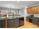 Well-lit kitchen with stainless steel sink, granite countertops, modern appliances, and hardwood floors at 9743 Aegean Ct, Huntersville, NC 28078