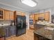Spacious kitchen with wood cabinetry, granite countertops, and stainless steel appliances at 9743 Aegean Ct, Huntersville, NC 28078