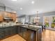 Open kitchen features granite countertops, stainless steel sink, two-tone cabinetry, and hardwood floors at 9743 Aegean Ct, Huntersville, NC 28078