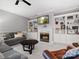 Bright living room features a gray couch, leather chair, and a fireplace with built-in bookcases at 9743 Aegean Ct, Huntersville, NC 28078