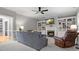Inviting living room with built-in bookshelves, a cozy fireplace, and comfortable seating at 9743 Aegean Ct, Huntersville, NC 28078