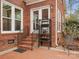 Brick patio area featuring stairs, an exterior door, and a decorative plant stand at 9743 Aegean Ct, Huntersville, NC 28078