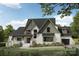 Charming two-story home featuring brick accents, a cozy porch, and well-manicured landscaping at Lot 4 Holbrook Rd, Fort Mill, SC 29715