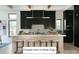 Modern kitchen with a center island, marble backsplash, sleek black cabinets, and stylish pendant lighting at Lot 4 Holbrook Rd, Fort Mill, SC 29715