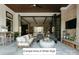 Relaxing covered patio with stone fireplace, comfortable seating, and retractable doors to the interior at Lot 4 Holbrook Rd, Fort Mill, SC 29715