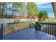 View of a black-stained wooden deck overlooking the fenced backyard and storage shed at 113 Tanager Dr, York, SC 29745