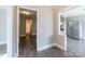 Bright hallway with updated gray flooring, leading to kitchen and a view of an en-suite bathroom at 113 Tanager Dr, York, SC 29745