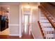 View of a light and airy hallway with hardwood floors and a staircase at 119 Snead Rd, Fort Mill, SC 29715